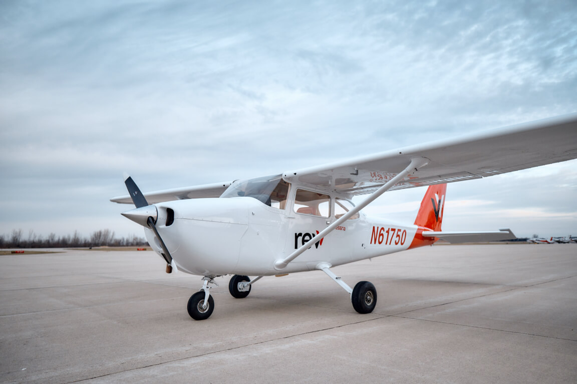 White and red Cessna 172 skyhawk branded with revv logo